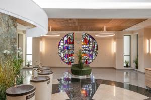 a lobby with a stained glass window and a fountain at Medical SPA "Eglės sanatorija" Standard Druskininkai in Druskininkai