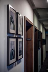 a row of framed pictures on a wall at Element in Alba Iulia