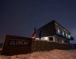 a black building with a sign in the snow at Element in Alba Iulia