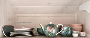 a shelf with plates and cups on a table at Tiny House Dreischwesternherz in Trier