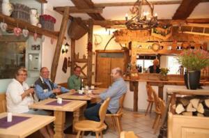 a group of people sitting at tables in a restaurant at Hotel Garni Kaiserpfalz in Goslar