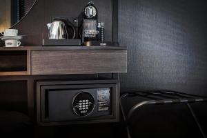 a room with a microwave and a coffee maker on a counter at The Loft Hotel Adults Only in Kraków