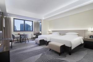 En eller flere senger på et rom på Hyatt Regency Metropolitan Chongqing