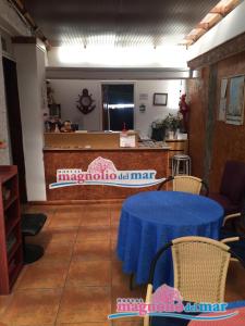 a room with a table and chairs and a counter at Hostal Magnolio in Viña del Mar