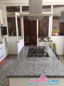 a kitchen with a stove top oven in a kitchen at Hostal Magnolio in Viña del Mar