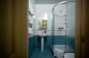 a bathroom with a sink and a shower at Hotel Complex Olimp in Umanʼ