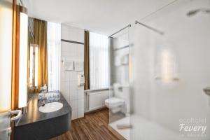 a bathroom with a sink and a shower at Hotel Fevery in Bruges