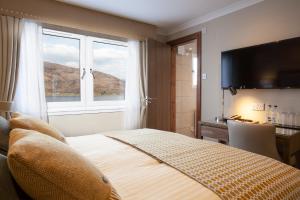 A bed or beds in a room at Cruachan Hotel