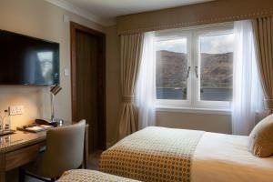 A bed or beds in a room at Cruachan Hotel