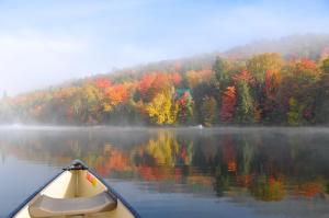 a kayak on a lake in the fall at Le Boisé du Lac in Mont-Tremblant