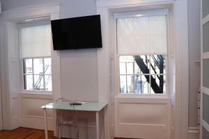 una camera con due finestre e una TV a parete di Downtown Beacon Hill, Convenient, Comfy Studio #10 a Boston