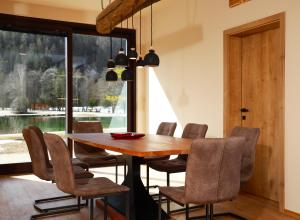 een eetkamer met een houten tafel en stoelen bij Jasna Chalet Resort in Kranjska Gora