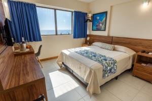 Tempat tidur dalam kamar di Rede Andrade Riviera Premium