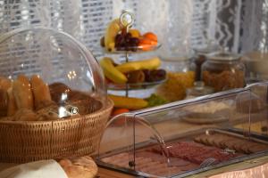 a table topped with a container of food and other foods at Villa Žerotín Penzion Bed & Breakfast in Velké Losiny