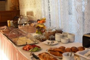 a table with a buffet of food on it at Villa Žerotín Penzion Bed & Breakfast in Velké Losiny