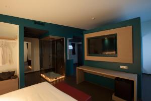 A bed or beds in a room at Hotel Carnia