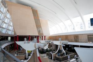 un grand bâtiment avec des tables blanches et un grand plafond dans l'établissement Hotel da Música, à Porto