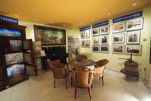 a room with a table and chairs and pictures on the wall at Hotel Montserrat in Sitges