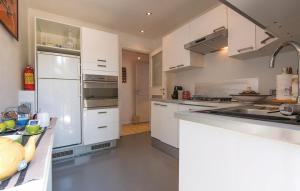 a kitchen with white cabinets and a white refrigerator at GAETA - Villa Fontania in Gaeta