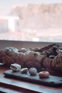 a pile of rocks sitting on a table next to a mirror at PEDRA DOS CORVOS Beach House in Odeceixe