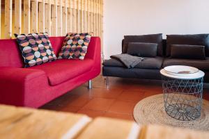 a living room with two couches and a table at PEDRA DOS CORVOS Beach House in Odeceixe