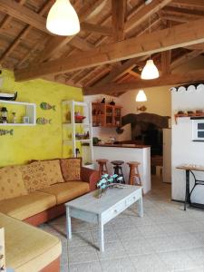 a living room with a couch and a table at Fisherman's House Azores in Angra do Heroísmo