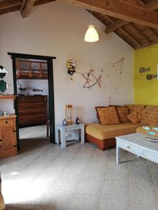 a living room with a couch and a table at Fisherman's House Azores in Angra do Heroísmo