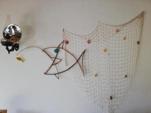 a net is hanging on a wall at Fisherman's House Azores in Angra do Heroísmo