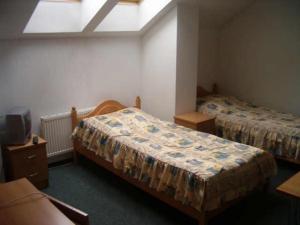 a hotel room with two beds and a tv at MOSiR Reda in Reda