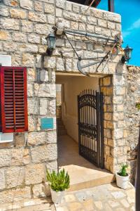 an entrance to a stone building with a gate at Villa Marinero in Ulcinj