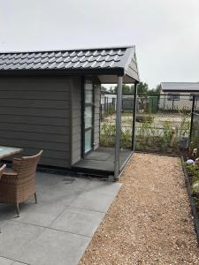 een paviljoen met een tafel en een patio bij Chalet SOL Y MAR in Renesse