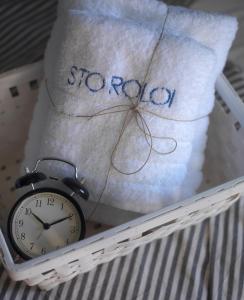 a alarm clock sitting next to a pillow with the word proxy at Sto Roloi Island Houses in Poros