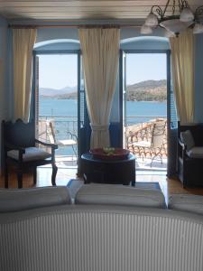 a living room with a view of the water at Sto Roloi Island Houses in Poros