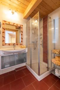 a bathroom with a shower and a sink at Hotel Zimmerbräu in St. Wolfgang