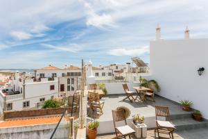 un balcone con sedie e tavolo su un edificio di 3 Marias Guest House B&B a Lagos