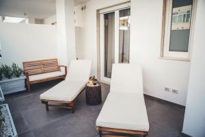 two white chairs in a room with a window at Terradamare in Monopoli