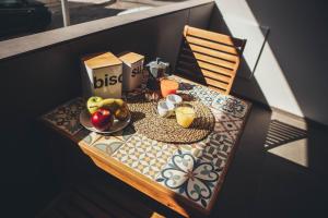 a table with a bowl of fruit on a balcony at Terradamare in Monopoli