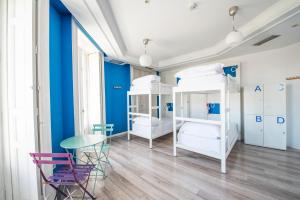 um quarto com 2 beliches, uma mesa e cadeiras em Safestay Madrid Central em Madrid