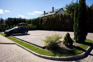 a car is parked in a parking lot at Villa Centrum Młodości in Augustów