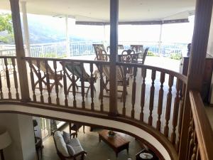 a spiral staircase with chairs and a table on a balcony at Beau Séjour Hotel in Victoria