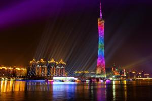 a tall tower lit up in rainbow colors at night at Paco Hotel Tiyuxilu Metro Guangzhou-Free Shuttle Bus for Canton Fair in Guangzhou