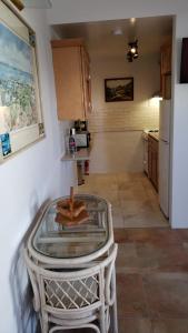 a kitchen with a table in the middle of a room at Pauls Oceanview with Amazing Sunsets in Hog Bay