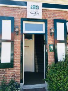 a door to a building with a sign on it at Gastenverblijf Neeltje in Oostkapelle