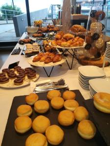 a table with buns and other pastries and other foods at Best Western Hotel Rome Airport in Fiumicino