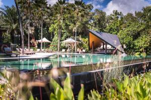 uma piscina em frente a um resort em Niramaya Villas and Spa em Port Douglas