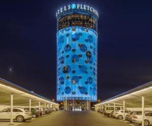 uma torre azul alta com um edifício no meio em Fletcher Hotel Amsterdam em Amesterdão