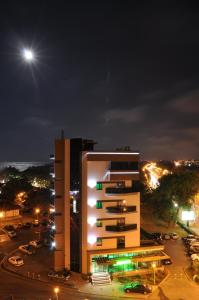 un edificio alto con parcheggio notturno di Hotel Scapino a Mamaia