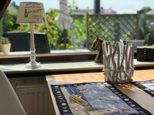 a table topped with a table with a sign and a table sidx sidx at Ferienhaus nähe Warnemünde in Elmenhorst