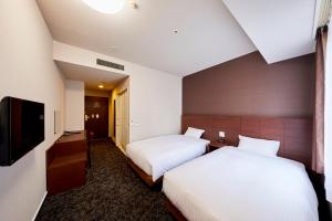 Кровать или кровати в номере Hotel Wing International Kobe - Shinnagata Ekimae