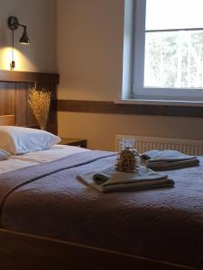 A bed or beds in a room at Sodyba Ignė